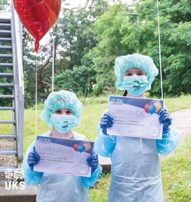 Zwei Kinder in OP-&Uuml;berziehkleidung